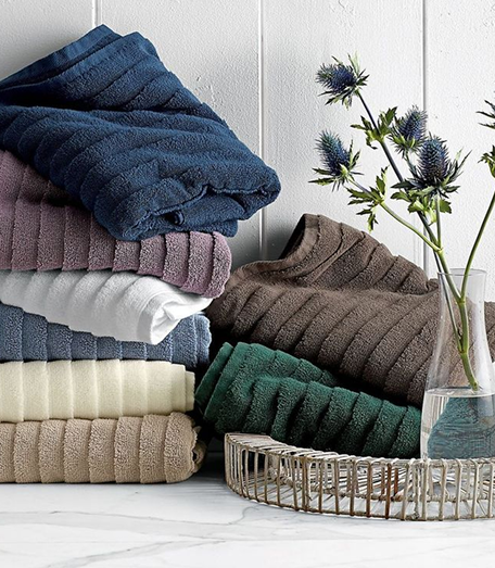 Stacked folded towels in blue and earth tones
